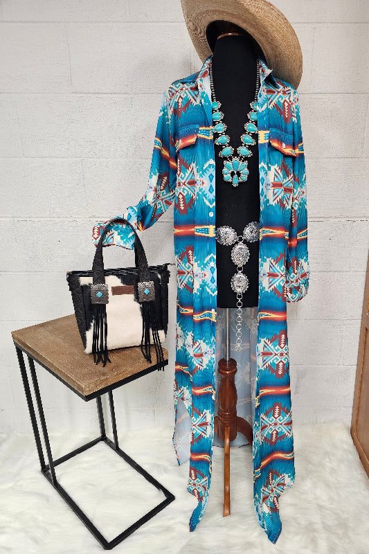 Mannequin wearing a colorful patterned kimono with a black handbag on a white background