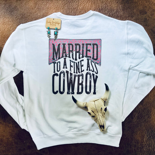 White sweatshirt with text and bull skull design on a brown leather surface