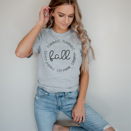 Woman wearing a gray t-shirt with 'fall' text against a plain background